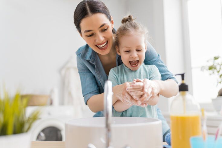 Girl And Her Mother Are Washing Hands